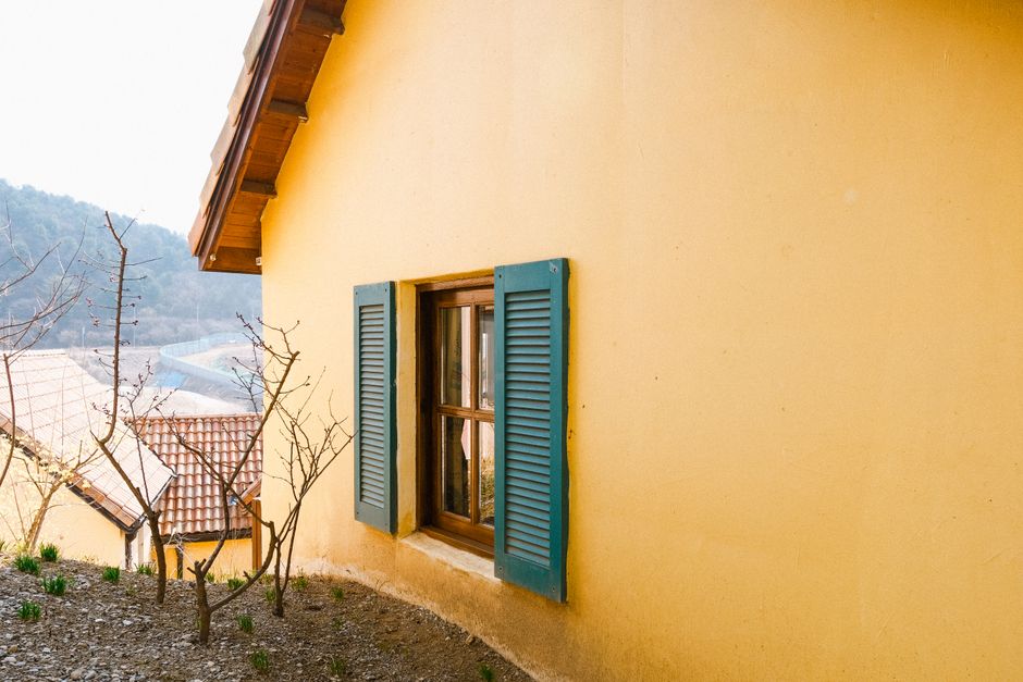 A weathered painted wall on a home exterior