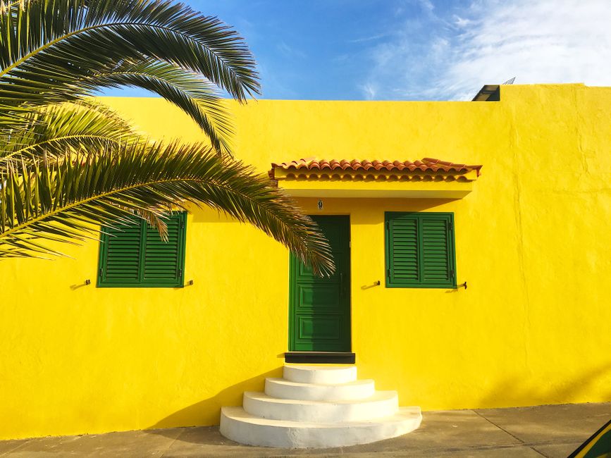 A weathered painted wall on a home exterior